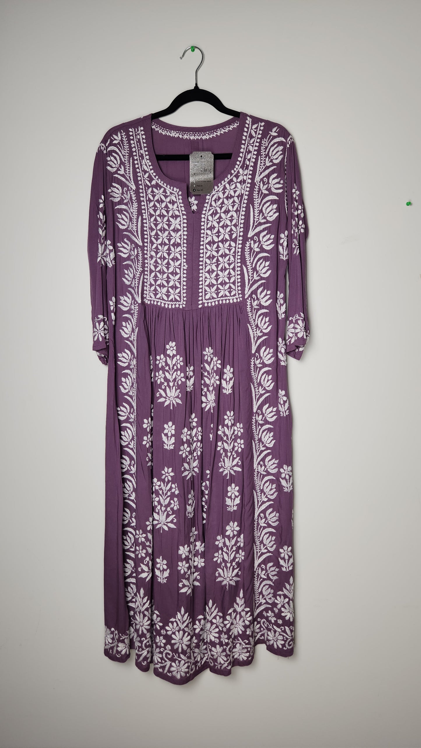 Purple garment bag with white floral patterns on a light gray background. Shop the world’s first best collection of elegant kurtis, beautiful maxi dresses, and premium cordsets—affordable, stylish, and crafted for boutique lovers in Auckland, New Zealand, and Australia. Premium quality meets cheap prices in fashion that’s both modest and stunning.