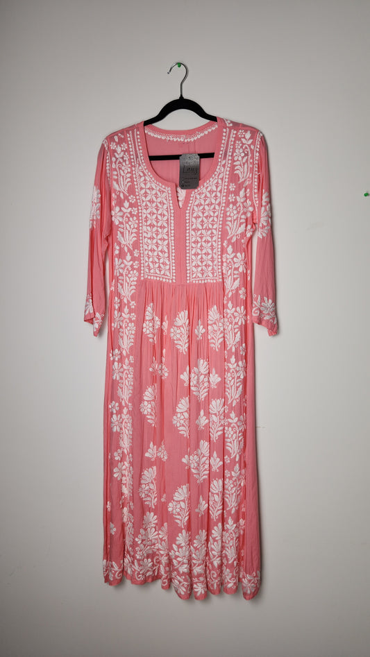 Pink dress with white floral pattern on a gray background. Affordable kurti with mirror work—crafted in New Zealand.  
