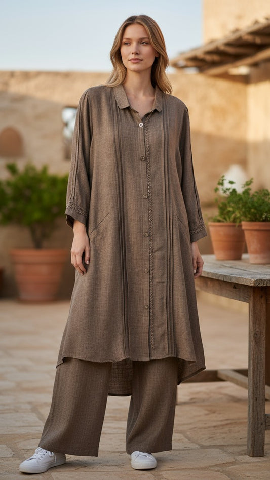 Woman wearing a long brown dress standing outdoors with a rustic background. Discover the world’s first best collection of elegant kurtis, beautiful maxi dresses, and premium-quality cordsets—crafted with care and designed to elevate modest fashion across Auckland, New Zealand, and Australia. Whether you're seeking affordable luxury or cheap chic, each piece blends boutique craftsmanship with stunning detail, offering the best in style without compromising on quality. From soft fabrics to graceful silhouett