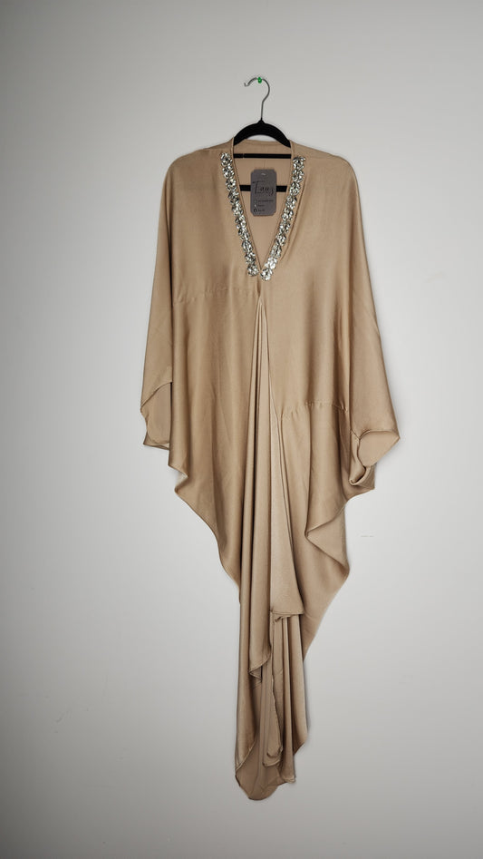 Beige dress on a hanger against a plain background. Premium quality cordset in soft satin, styled with modest flair. 