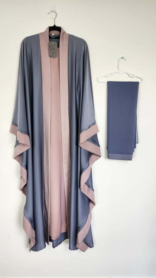 Long robe with pink accents on a hanger against a white background